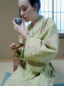 Traditional Japanese Green and pink Yakata and view of the room inside Ryokan drinking green tea